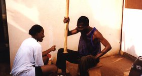 Pounding fufu, a traditional Ghanaian dish.