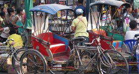 Bicycle taxis are common in the suburbs.