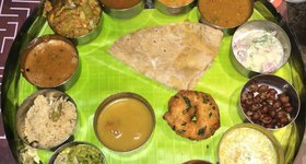 A traditional Thali meal, served on a banana leaf